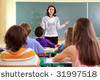 Stock-photo-teacher-and-student-in-a-classroom-at-school-31997518.jpg